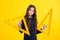 Back to school. School girl hold ruler measuring  on yellow background. Angry teenager girl, upset and unhappy