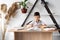 Back to school. Schoolboy boy reading books at the table in the library or home school. Pupil in class at a table with