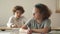 Back-to-school. Schoolchildren are sitting at their desks in class. The boy is late, the girl looks reproachfully