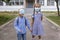 Back to school. Siblings with backpacks in medical masks stay near doors before first offline day