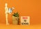 Back to school and support symbol. Concept words Back to school on wooden blocks. Businessman model. Beautiful orange table orange