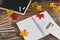 Back to school tabletop arrangement with coloured pencils notepad and mixed stationery items among autumn leaves