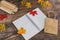 Back to school tabletop arrangement with coloured pencils notepad and mixed stationery items among autumn leaves