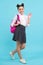 Back to school. Teenager schoolgirl in school uniform with bag. 1 september, knowledge day. School children on blue