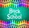 Back to School Text on Green Chalkboard Background with Different Colored Crayons