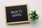 BACK TO SCHOOL text in white chalk handwriting on a blackboard