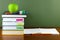 Back to school- textbooks and apple on the wooden desk