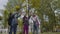 Back to school. Three Friends With Backpacks huging and laughing in front of school. Mixed Racial Group of School Kids