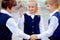 Back to school: three school children boys and a girl wearing uniform playing and laughing