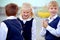 Back to school: three school children boys and a girl wearing uniform playing and laughing