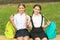 back to school. two smiling teenager children after school outdoor. friendship of school girls