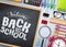 Back to school vector banner. Chalkboard with back to school text and colorful school supplies and elements