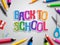 Back to school vector design with colorful paper cut text, education elements and school supplies