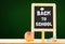 Back to school word on blackboard on wood table with apple,chalk at green background,Education concept