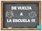 Back to school written chalk on a blackboard. In Spanish.