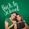 Back To School Written On Chalk Board Behind Proud Hispanic Mom