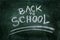 Back to school written in chalk on dirty chalkboard