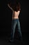 Back of topless skinny guy in blue jeans isolated