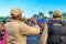 Back of two policemen taking pictures of costume people at Bloco Orquestra Voadora in Flamengo Park, Carnaval 2017