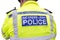 Back of the vest of a London Metropolitan Police Officer in Hi-visibility Uniform  on white background