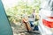 Back view adult woman working on laptop pc with blank screen while lying in hammock near motorhome on camping trip