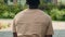Back view African American mad angry worried anxious stressed man guy student male businessman in city outdoors suffer