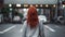 Back view of anonymous female with red hair standing near crosswalk