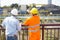 Back view of architects inspecting construction site