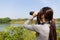 The back view of Asian Young woman using binocular