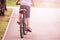 Back view of an athlete on a professional bicycle riding on empty highway.