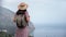 Back view backpacker travel woman admiring nature scenery mountain top over sea relaxing freedom