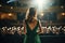 back view of beautiful woman in green dress standing in auditorium and looking away, Back view of a girl in a green evening dress