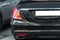 Back view of big luxury expensive sedan car trunk. Black colored