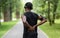 Back view of black man in sportswear touching injured back