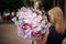 Back view of blonde girl with big magnificent bouquet