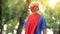 Back view of boy in superman costume, dreamy child, recreational activity