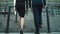 Back view business couple going upstairs. Legs walking at stairs in shoes