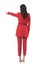 Back view of business woman leader in red suit pointing finger showing directions.