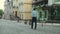 Back view businessman enjoying downtown. Businessman walking at empty street