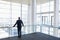 Back view of businessman looking out of office window