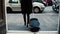 Back view of businesswoman walking with a suitcase in the tunnel. Girl goes out of entrance in the city. Slow motion.