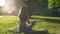 Back view of calm young woman meditating in lotus pose holding hands on knee in Om position.