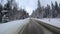 Back view from car mounted camera when vehicle driving winter snowy forest road. Video 4k