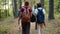 Back view of cheerful young people friends walking talking doing high-five