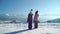 Back view of children standing on rural roadway in snow looking at mountain range in sunshine