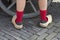 Back view of classic Dutch wooden shoes worn with red socks