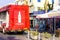 Back view of Coca-Cola delivery truck stand near retailer shop