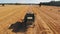 Back view of combine harvester working on the field. Aerial slow motion