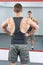 Back view of confident and masculine man at the gym