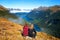 Back view of couple travellers in front of stunning mountain valley lake view, Key Summit Route Burn Track, Fiordland, New Zealand